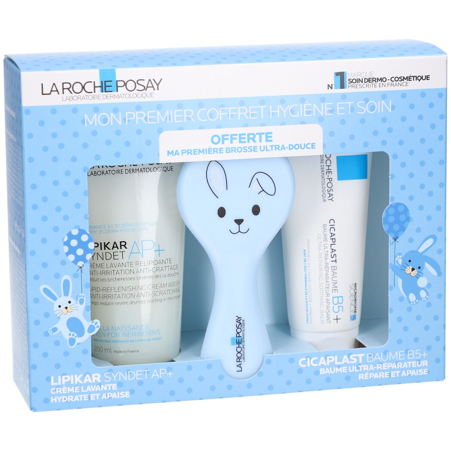 Coffret de soins pour bébé. Contient crème, baume et brosse bleue en forme de lapin. Texte: LA ROCHE POSAY.