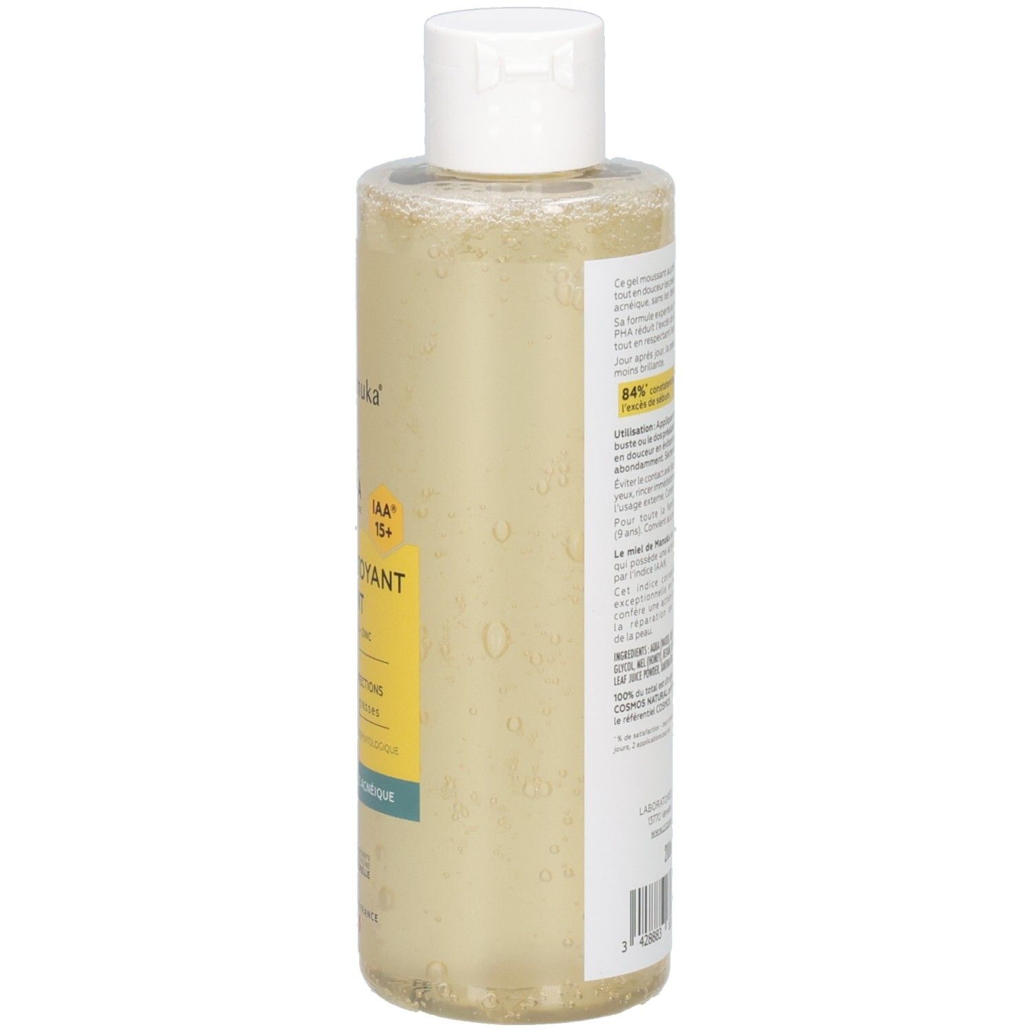 Côté du flacon avec texte. Liquide jaune visible. Bouchon blanc. Inscription: CicaManuka.