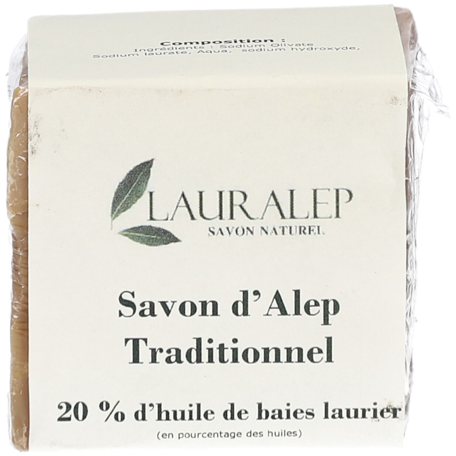 Bloc de savon carré, emballé dans du papier et du film plastique. Inscription : LAURALEP, Savon d'Alep Traditionnel, 20% huile de baies laurier.