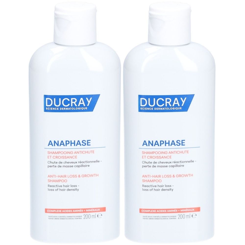 Deux flacons blancs de shampooing DUCRAY ANAPHASE. Étiquettes bleues et orange avec nom et texte du produit. Bouchons blancs.