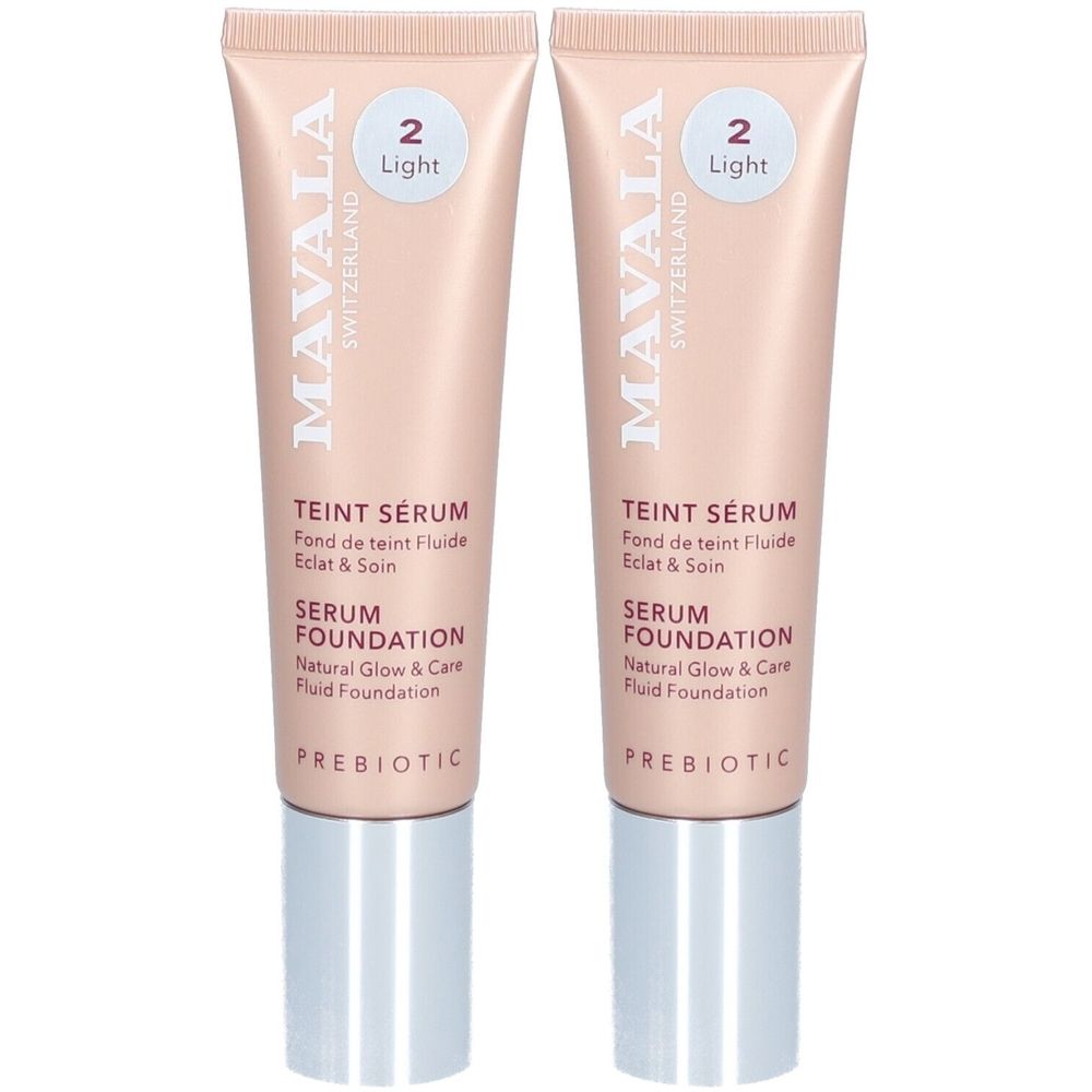 Deux tubes de Mavala Teint Serum Light. Tubes rose clair avec bouchons argentés. Texte: Teint Serum, Serum Foundation, Prebiotic.