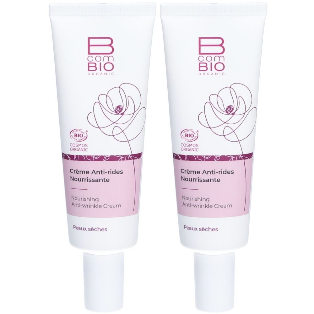 Deux tubes de crème. Blancs, avec accents roses et motif floral. Texte: B COM BIO, Crème Anti-rides Nourrissante, BIO COSMOS ORGANIC.
