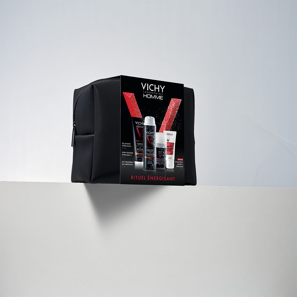 Trousse de toilette noire avec emballage produits. Inscription: VICHY Homme, Rituel Énergisant. Sur fond blanc.