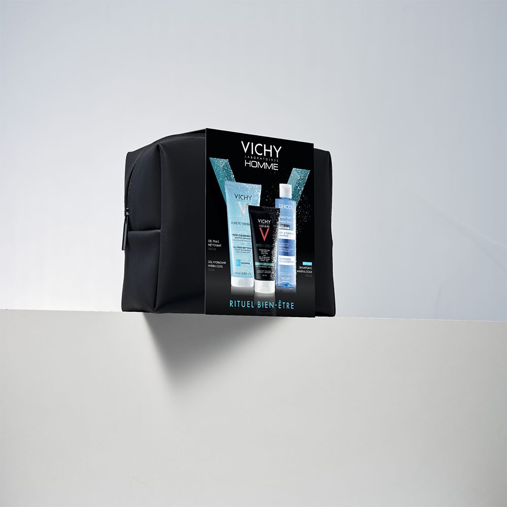 Trousse de toilette noire avec set Vichy Homme. Set de trois produits, sur une surface blanche.