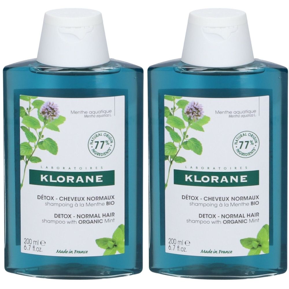 Deux flacons de shampooing KLORANE. Liquide turquoise, bouchon blanc. Étiquette avec logo, texte et illustration de menthe. "DETOX - NORMAL HAIR".