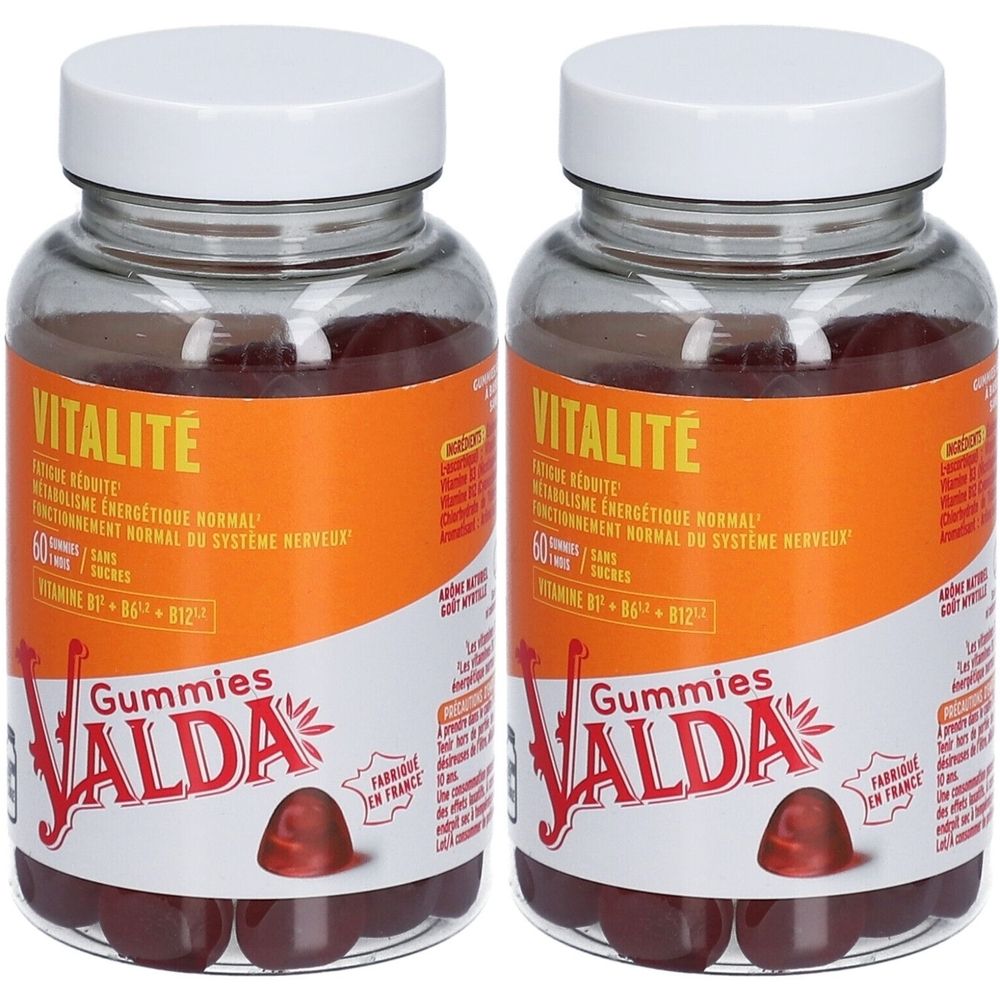 Deux flacons en verre avec des couvercles blancs. Les étiquettes indiquent VALDA Vitalité Gummies. Des gommes sont visibles.