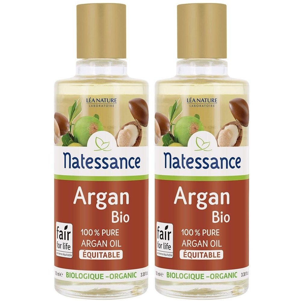 Deux flacons avec bouchons dorés. Étiquettes : "Natessance Argan Bio 100% Pure Argan Oil". Logo avec fruits d'argan.