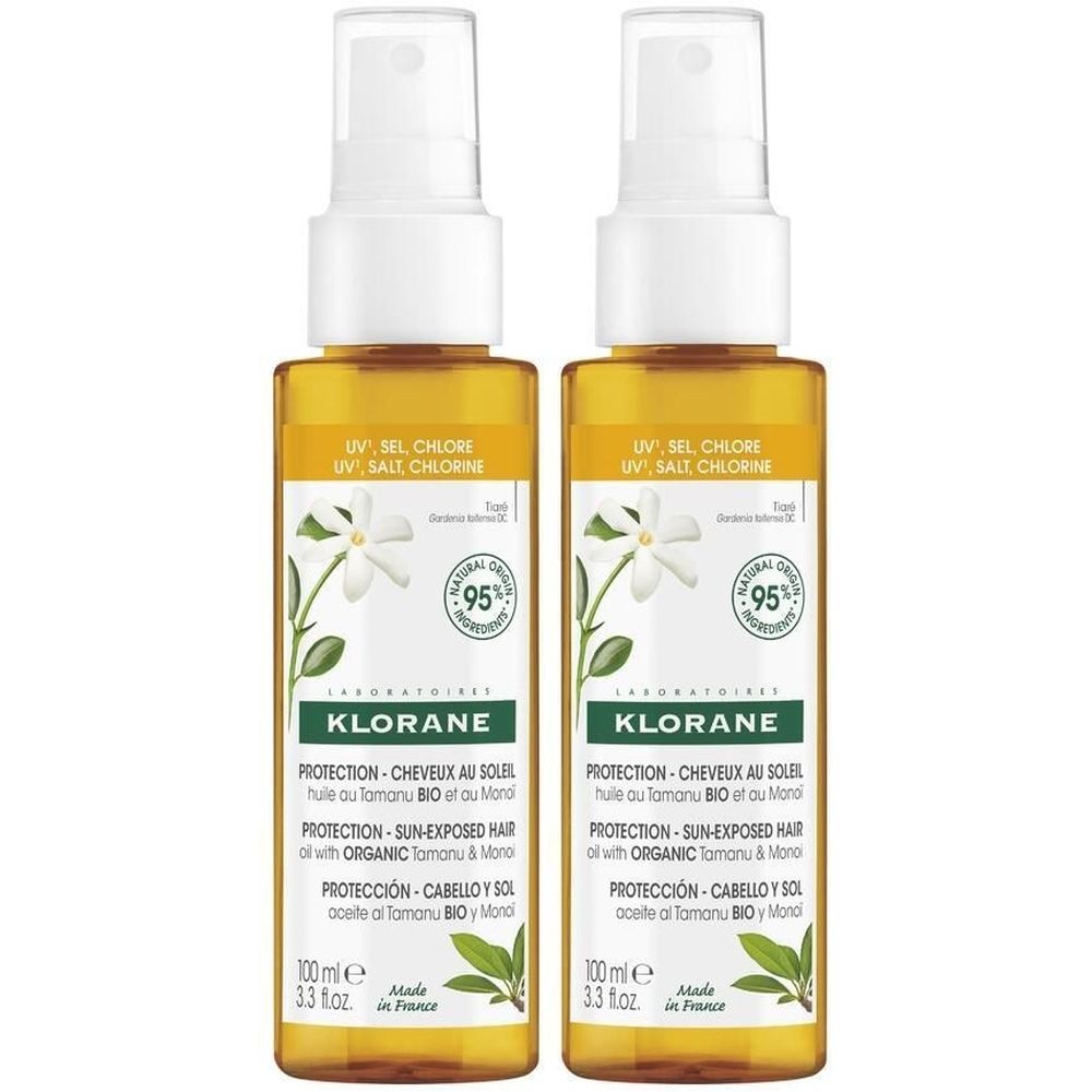 Deux flacons d'huile capillaire KLORANE. Liquide jaune dans des flacons transparents avec vaporisateur. Inscription : Protection solaire, sel et chlore.