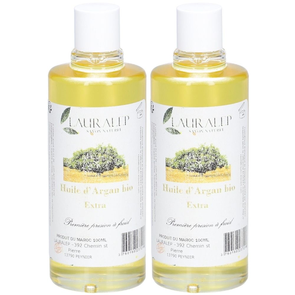 Deux flacons d'huile jaune. Étiquettes avec "Huile d'Argan bio Extra" et "LAURALEP". Bouchons blancs.