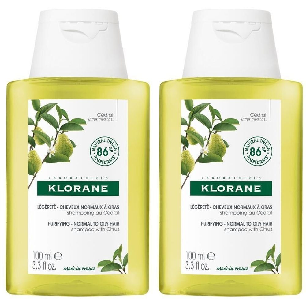 Deux flacons de shampooing jaunes avec bouchon blanc. Inscription: KLORANE, 86% ingrédients naturels, pour cheveux normaux à gras. 100 ml.