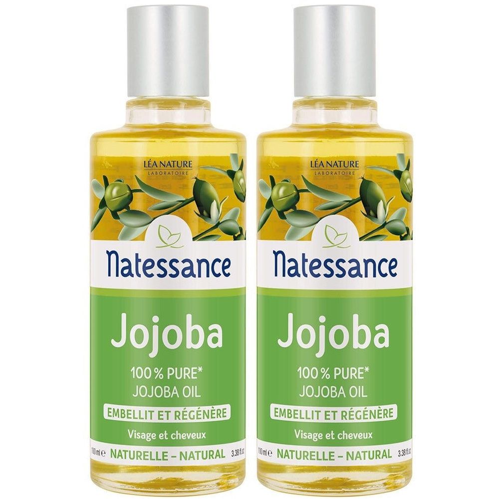 Deux flacons d'huile de jojoba Natessance. Inscription : 100% huile de jojoba pure. Pour le visage et les cheveux. Étiquettes vertes et blanches.