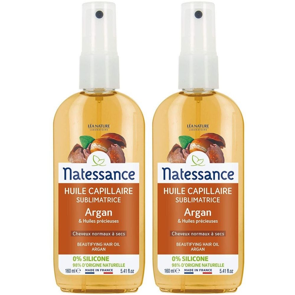 Deux flacons pulvérisateurs de liquide jaune. Inscription: Natessance Huile Capillaire Sublimatrice Argan. Étiquette avec texte et logo.