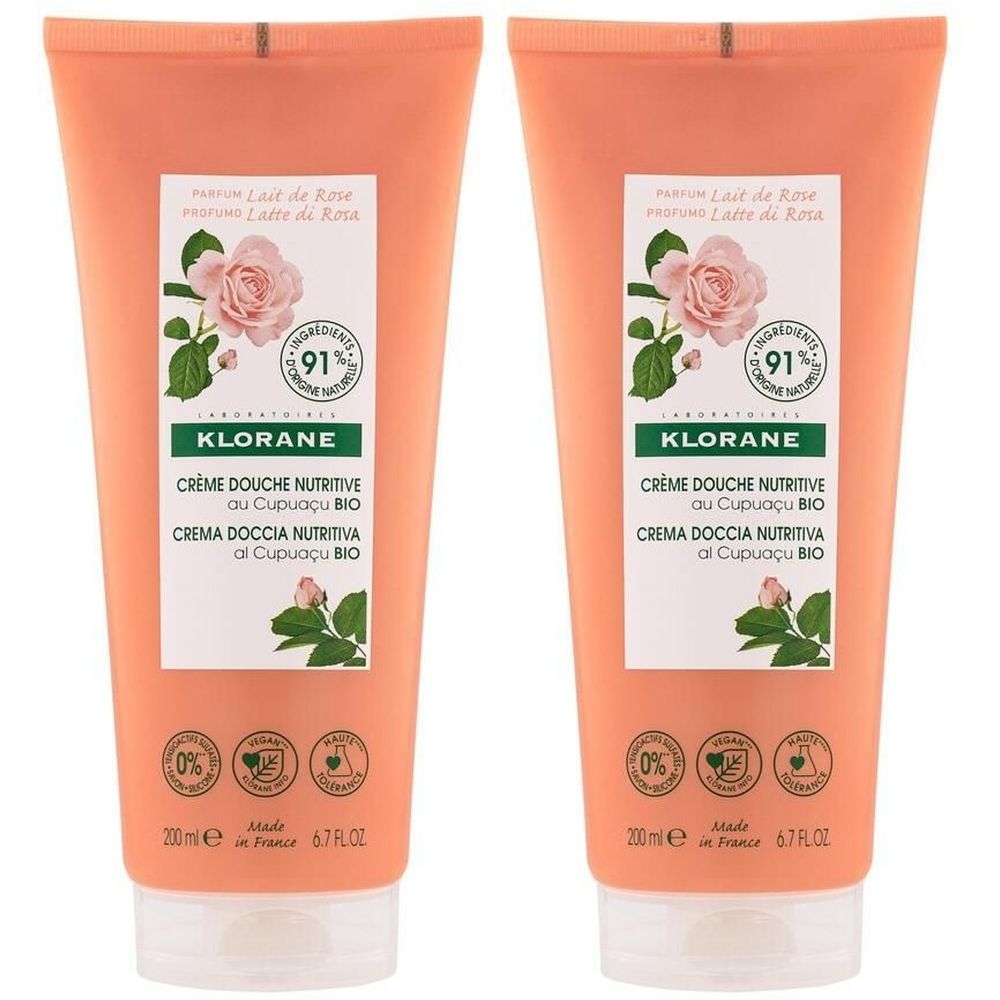 Deux tubes de KLORANE Crème Douche. Emballage rose avec informations produit et illustration de rose. Label vegan.