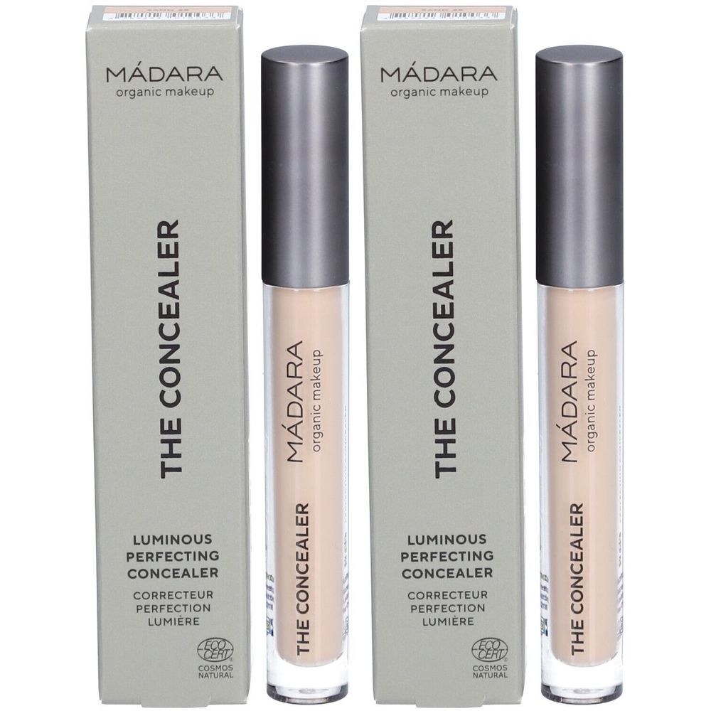 Deux tubes de correcteur et leurs emballages. Sur les emballages, on lit "Mádara THE CONCEALER". Les correcteurs sont beige clair.