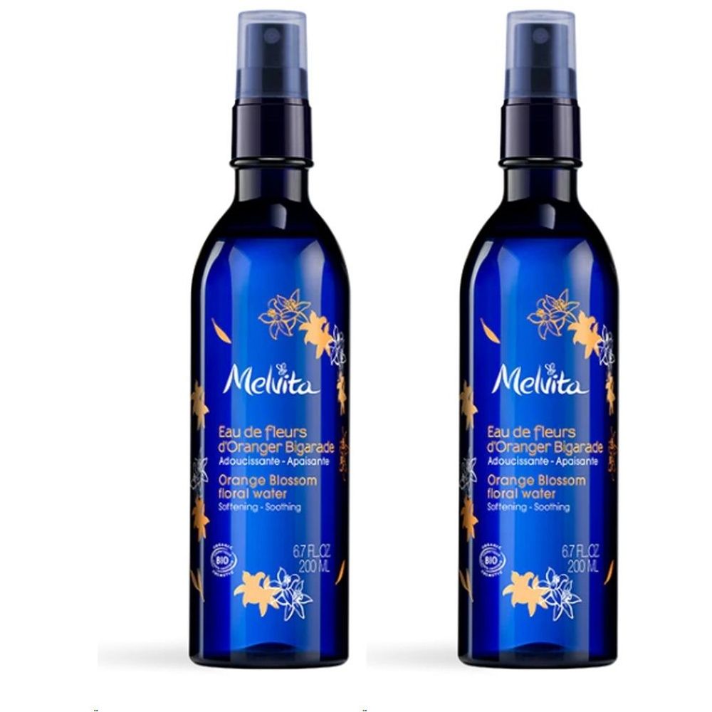 Deux flacons bleus avec vaporisateur. Inscription: Melvita, Eau de fleurs d'Oranger Bigarade, Orange Blossom floral water. 6.7 fl.oz. 200 ml.
