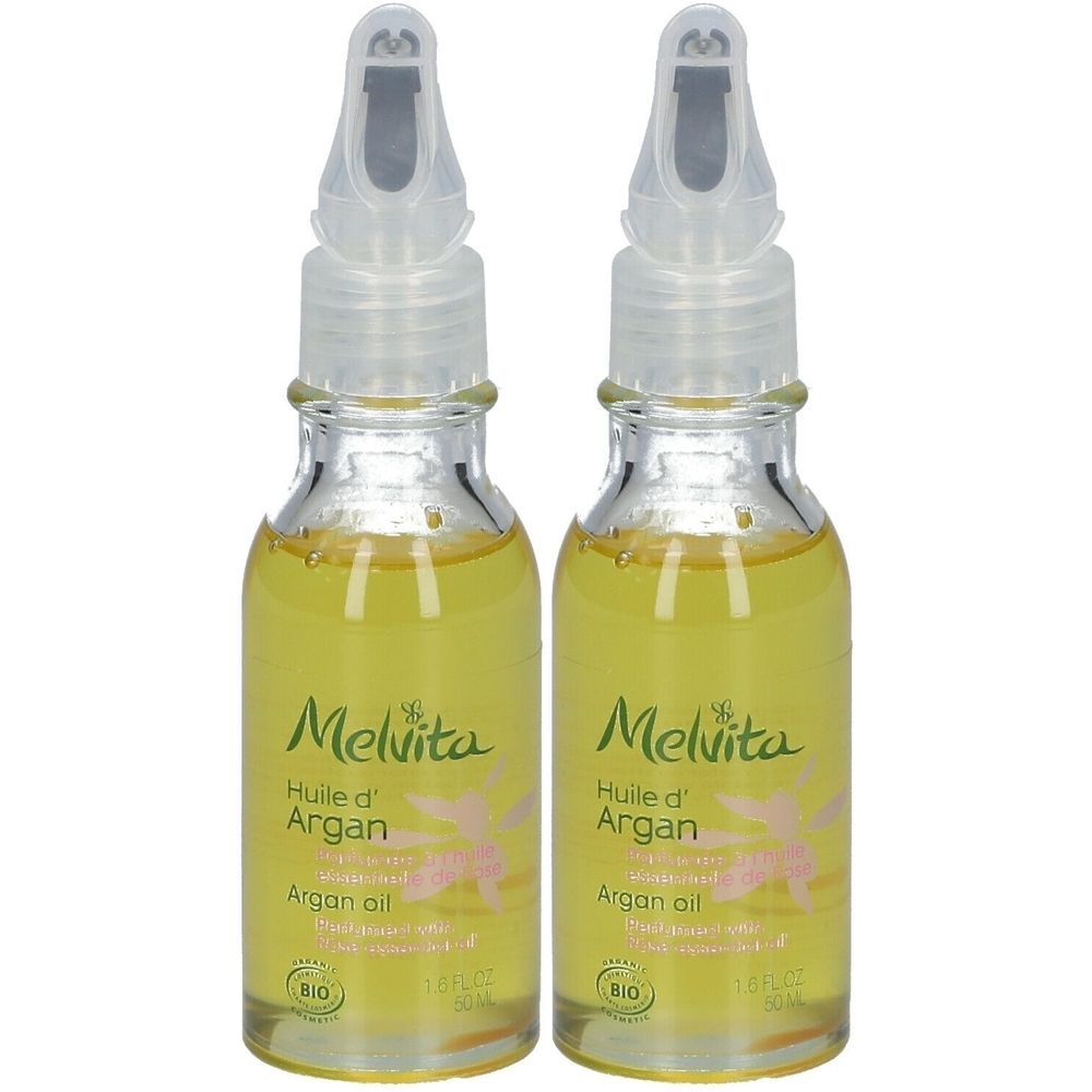 Deux flacons en verre contenant de l'huile jaune. Chaque flacon porte l'inscription "Melvita Huile d'Argan". Ils ont un applicateur transparent.