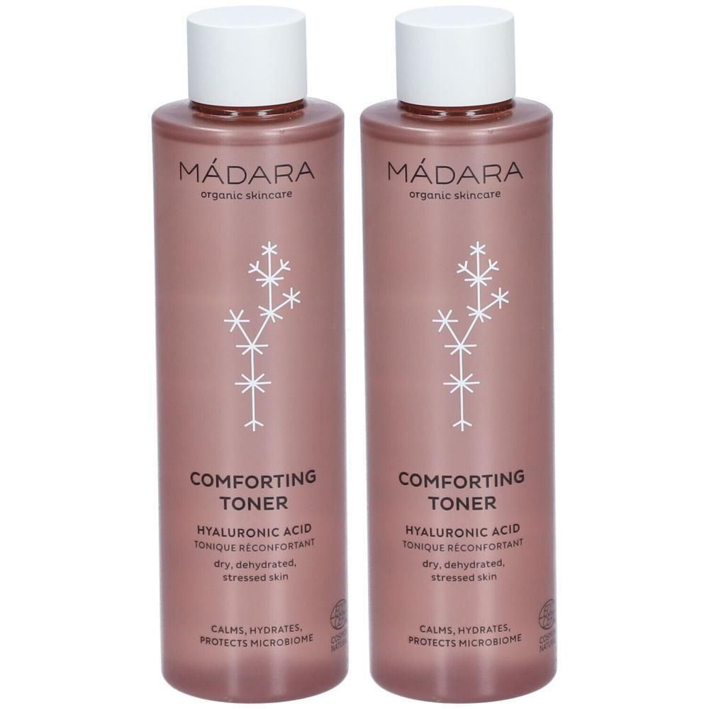 Deux flacons de toner Mádara. Flacons roses avec bouchons blancs. Inscription : Comforting Toner, acide hyaluronique.