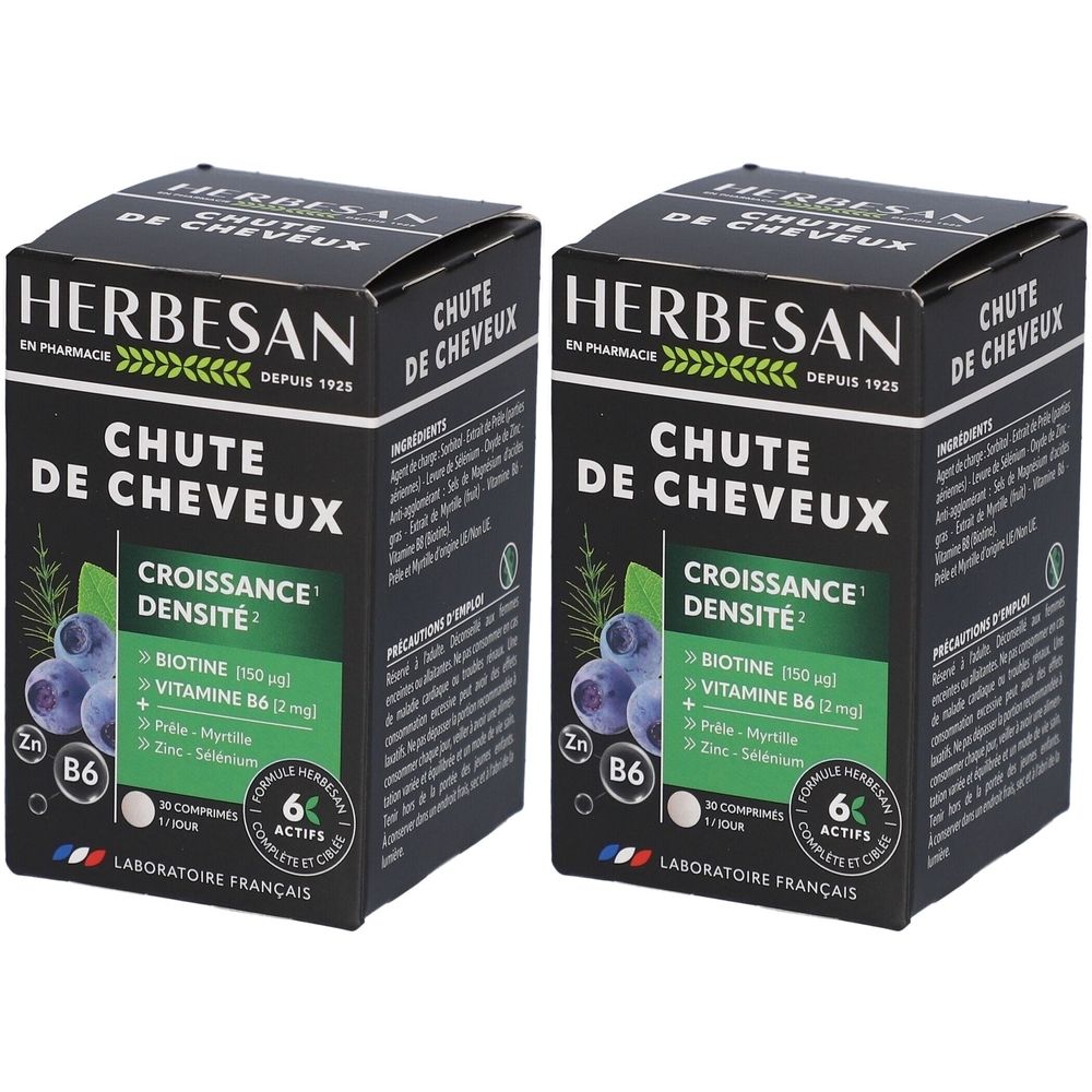Deux boîtes Herbesan Chute de Cheveux. Emballage noir, texte blanc. Contient biotine, vitamine B6, zinc et sélénium.