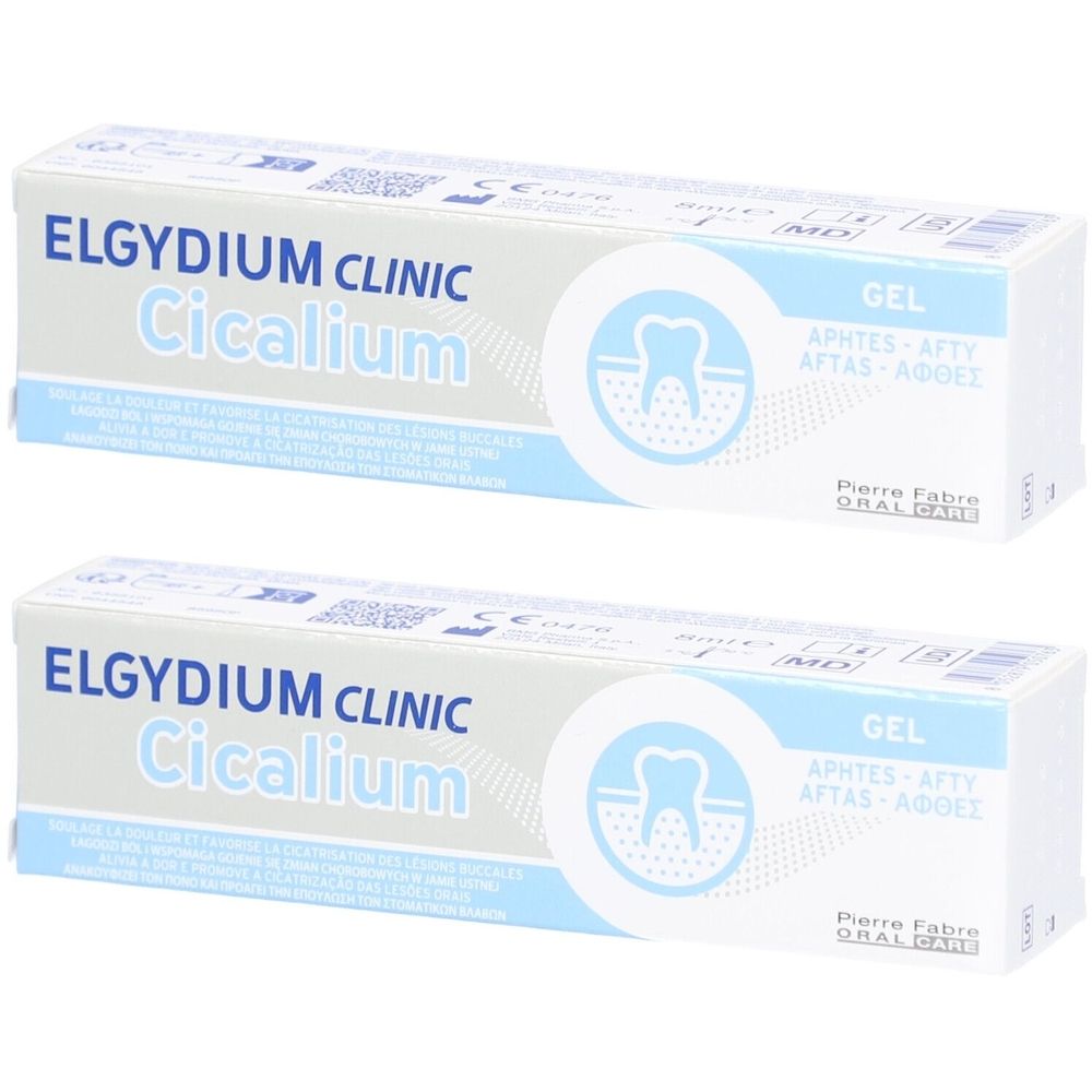 Deux tubes de gel Elgydium Clinic Cicalium. Emballage blanc avec texte bleu et symbole dentaire. Texte: GEL, APHTES-AFTY, AFTAS-ΑΦΘΕΣ.