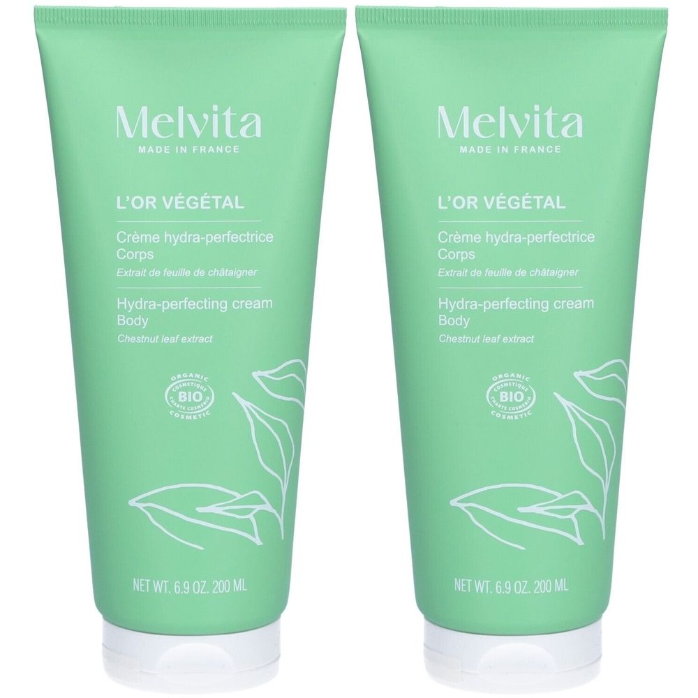 Deux tubes verts avec texte blanc. Inscription : Melvita, L'Or Végétal, Crème hydra-perfectrice Corps. Certification Bio.