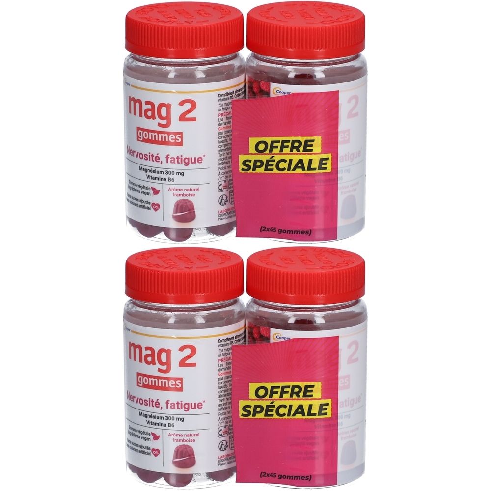 Quatre flacons avec bouchons rouges et étiquettes. Inscription : mag 2 gommes, Offre Spéciale. Gommes visibles.