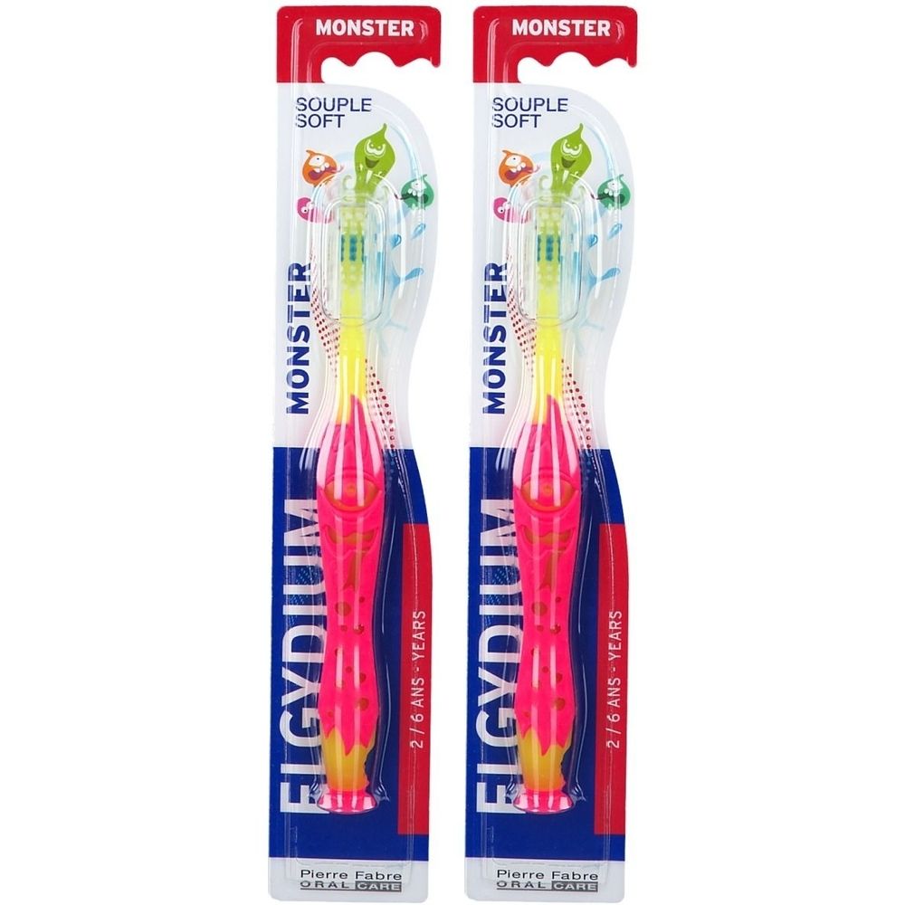 Deux brosses à dents pour enfants dans un emballage. Manche rose, tête jaune. Inscriptions: ELGYDIUM, MONSTER, 2/6 ANS - YEARS.