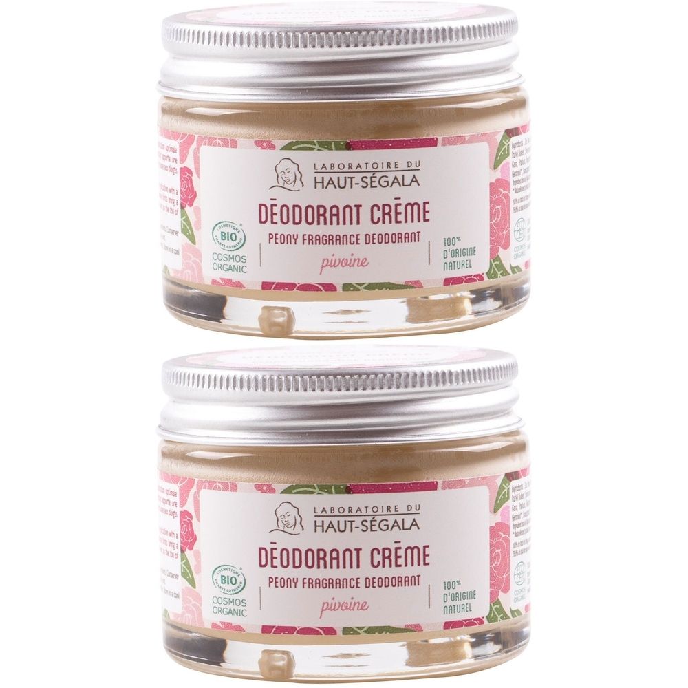 Deux pots de crème déodorante. Étiquette avec texte et motifs floraux. Couvercles métalliques. Certification bio.