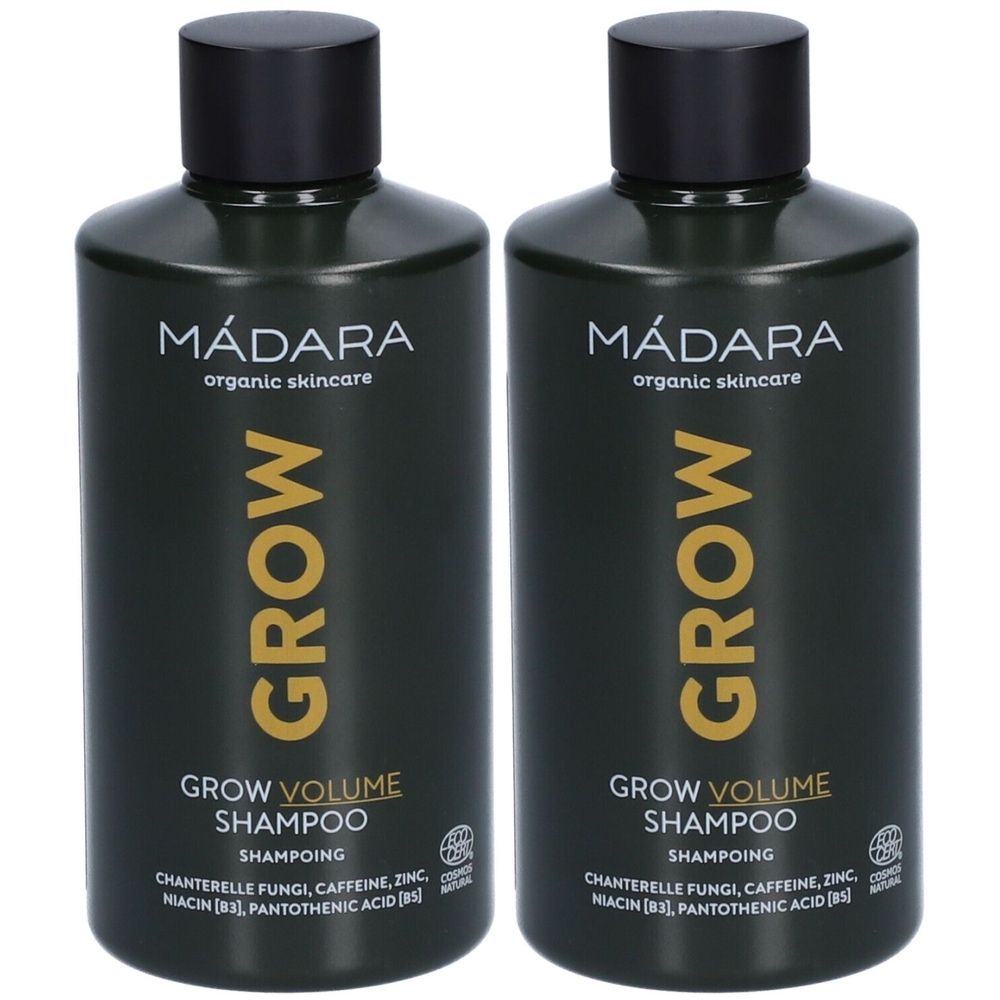 Deux flacons de shampooing Mádara Grow Volume. Flacons vert foncé avec bouchon noir. Inscription : Grow Volume Shampoo.