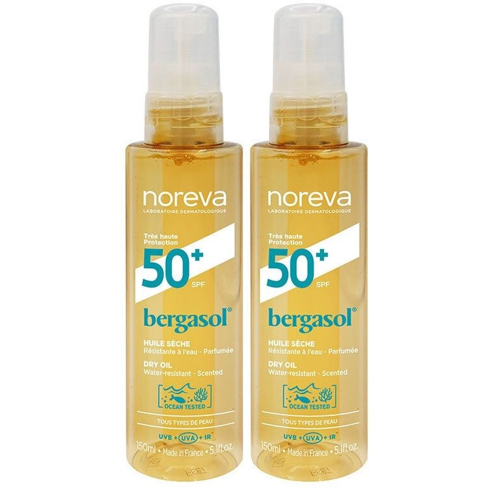 Deux flacons de protection solaire. Inscription: Noreva Bergasol Huile Sèche SPF50+. Avec vaporisateur et bouchon blanc. Liquide jaune.