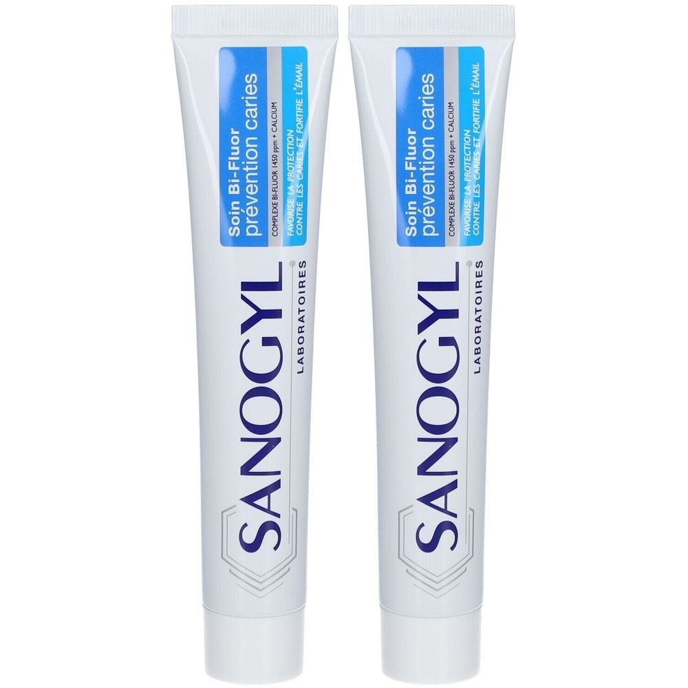 Deux tubes de dentifrice. Inscription : Soin Bi-Fluor, Sanogyl. Emballage bleu et blanc. Texte en français.