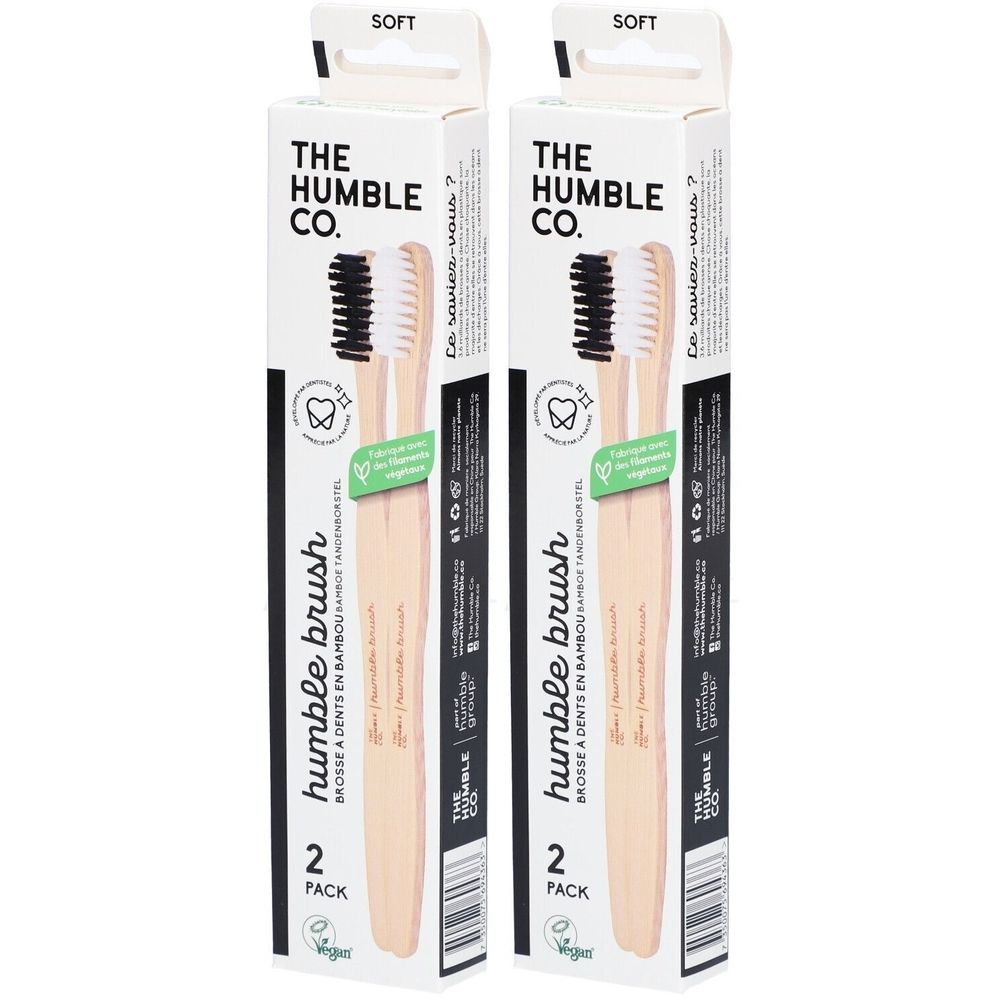 Deux brosses à dents dans un emballage. Marque : The Humble Co. Inscription : Humble brush, 2 Pack. Soies : noir et blanc. Emballage : blanc.