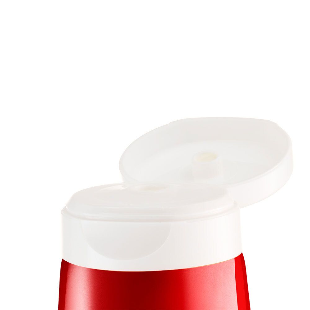 Gros plan d'un bouchon blanc ouvert sur un tube rouge.