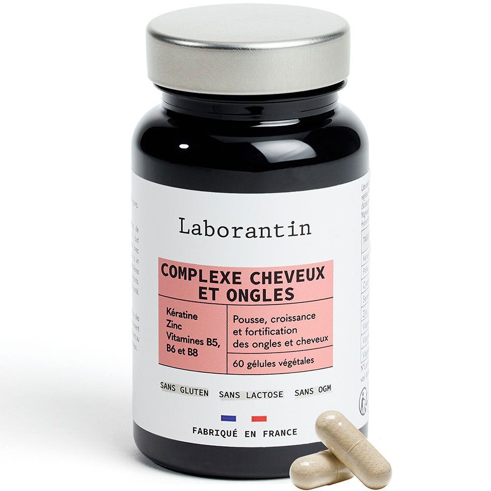 Flacon noir, bouchon argenté. Étiquette avec nom et ingrédients. Deux gélules à côté.