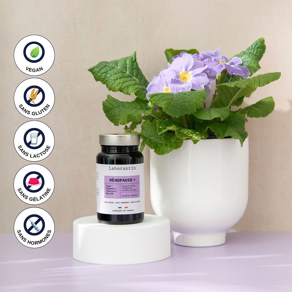 Flacon à côté d'un pot de fleurs violettes. Vegan, sans gluten, sans lactose, sans gélatine, sans hormones.