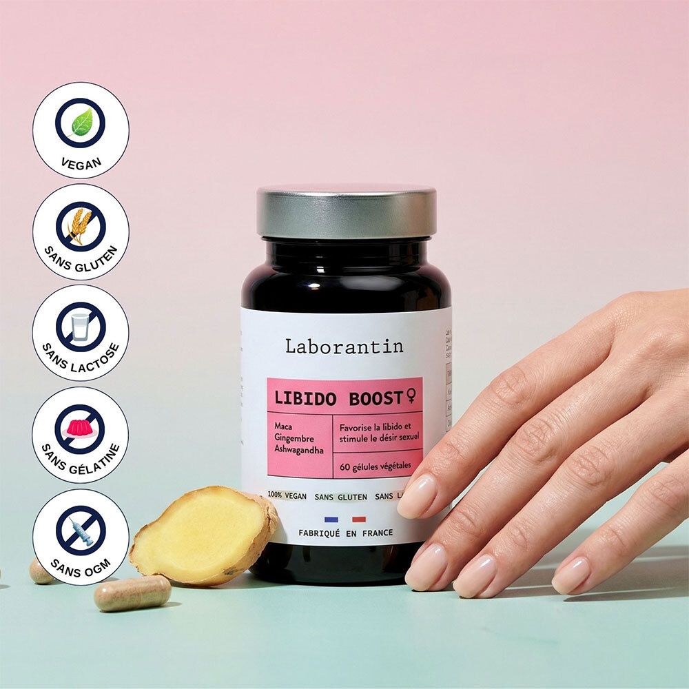 Flacon Laborantin Libido Boost Frau. Citation et avis. Main touchant le flacon. Fond vert et turquoise.