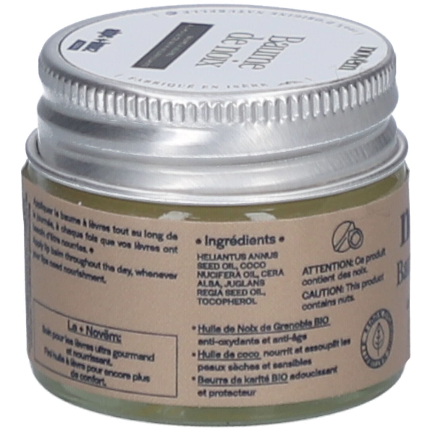 Pot en verre avec couvercle argenté. Étiquette avec ingrédients et avertissement sur les noix. Texte: Huile de noix de Grenoble BIO, Huile de coco, etc.