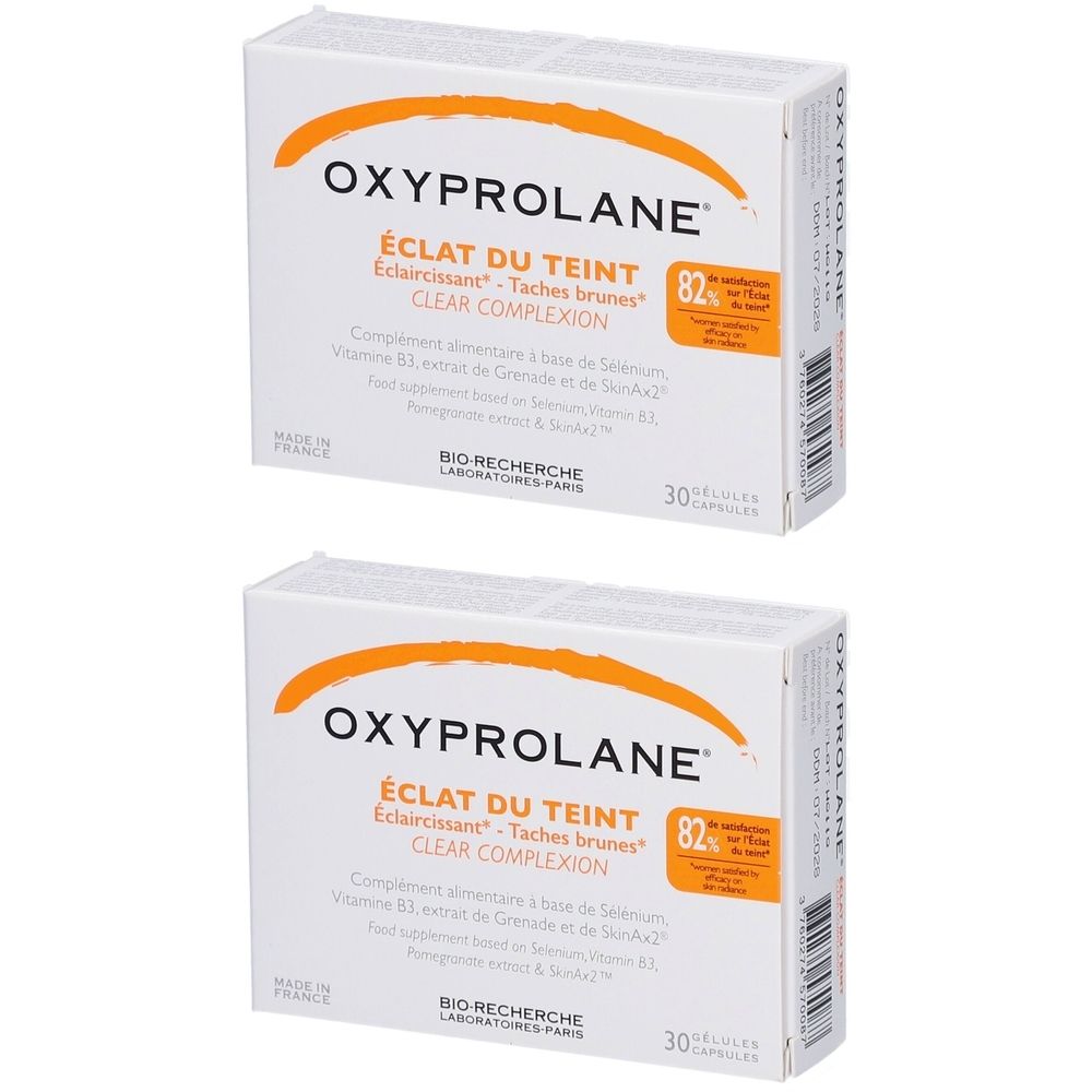 Deux boîtes blanches avec arc orange. Inscription: OXYPROLANE, ÉCLAT DU TEINT, CLEAR COMPLEXION. 30 gélules.