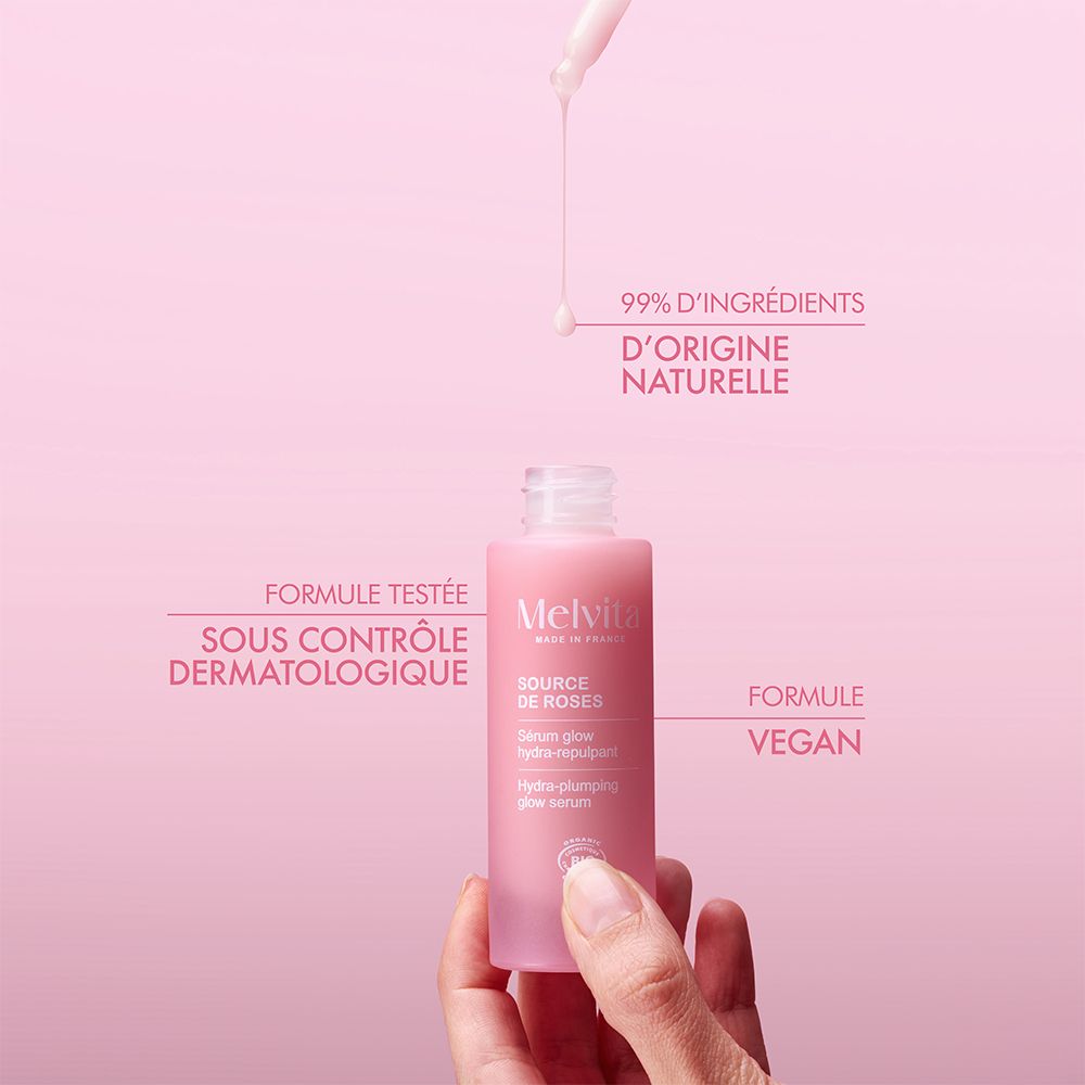 Flacon rose avec pipette. Texte : 99% d'origine naturelle. Testé dermatologiquement.