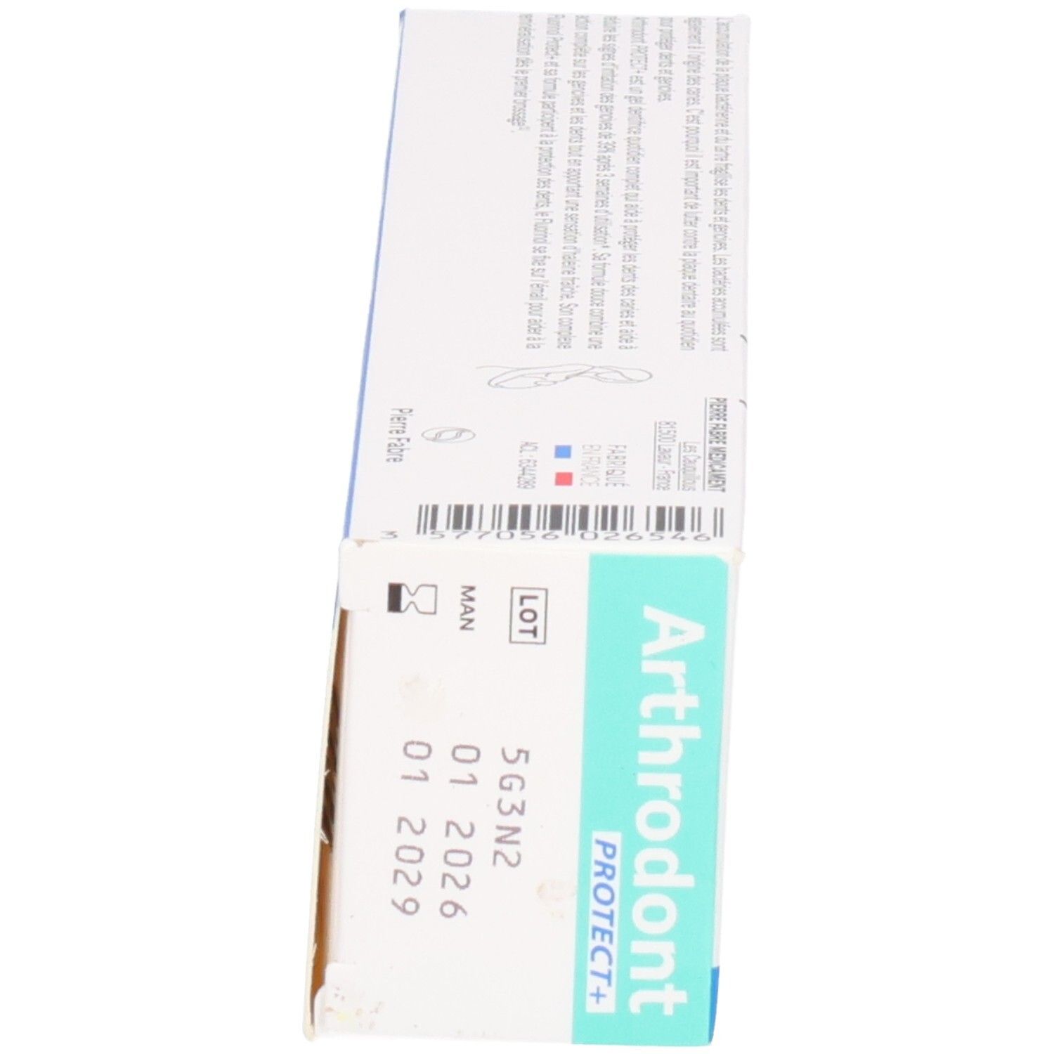 Boîte, vue oblique latérale. Nom et logo du produit visibles. Couleurs turquoise et blanc. Numéro de lot.