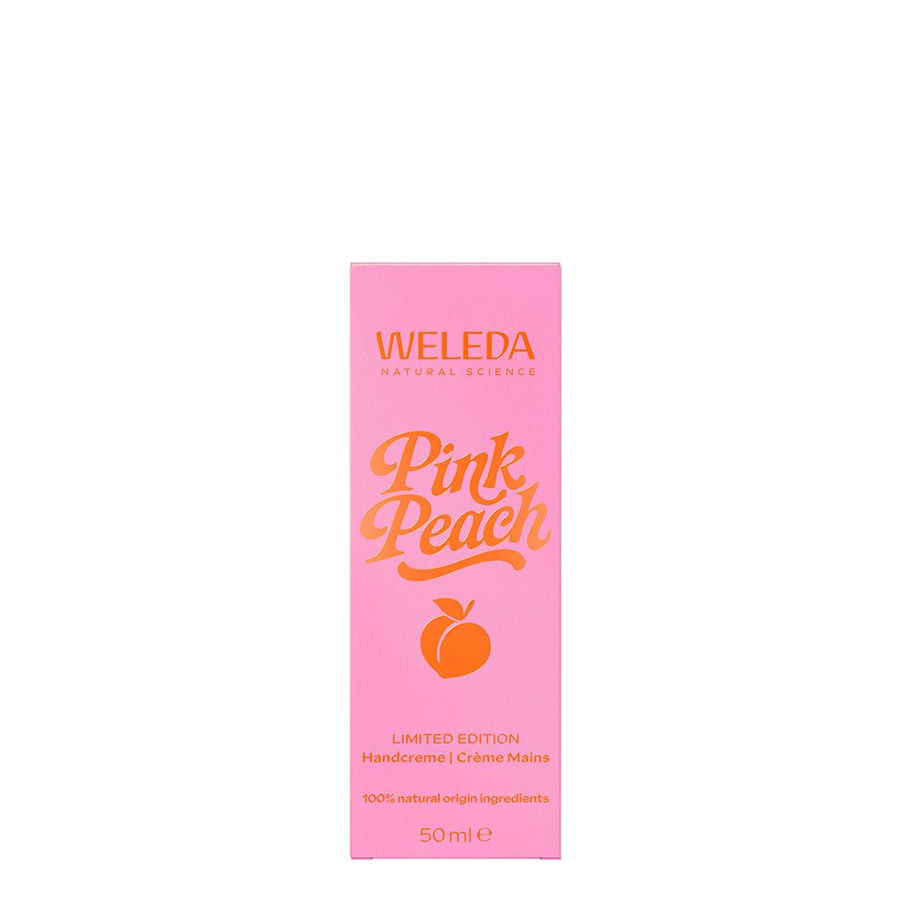 Boîte rose avec texte orange Pink Peach. Marque Weleda. Édition limitée Crème Mains. Ingrédients naturels.