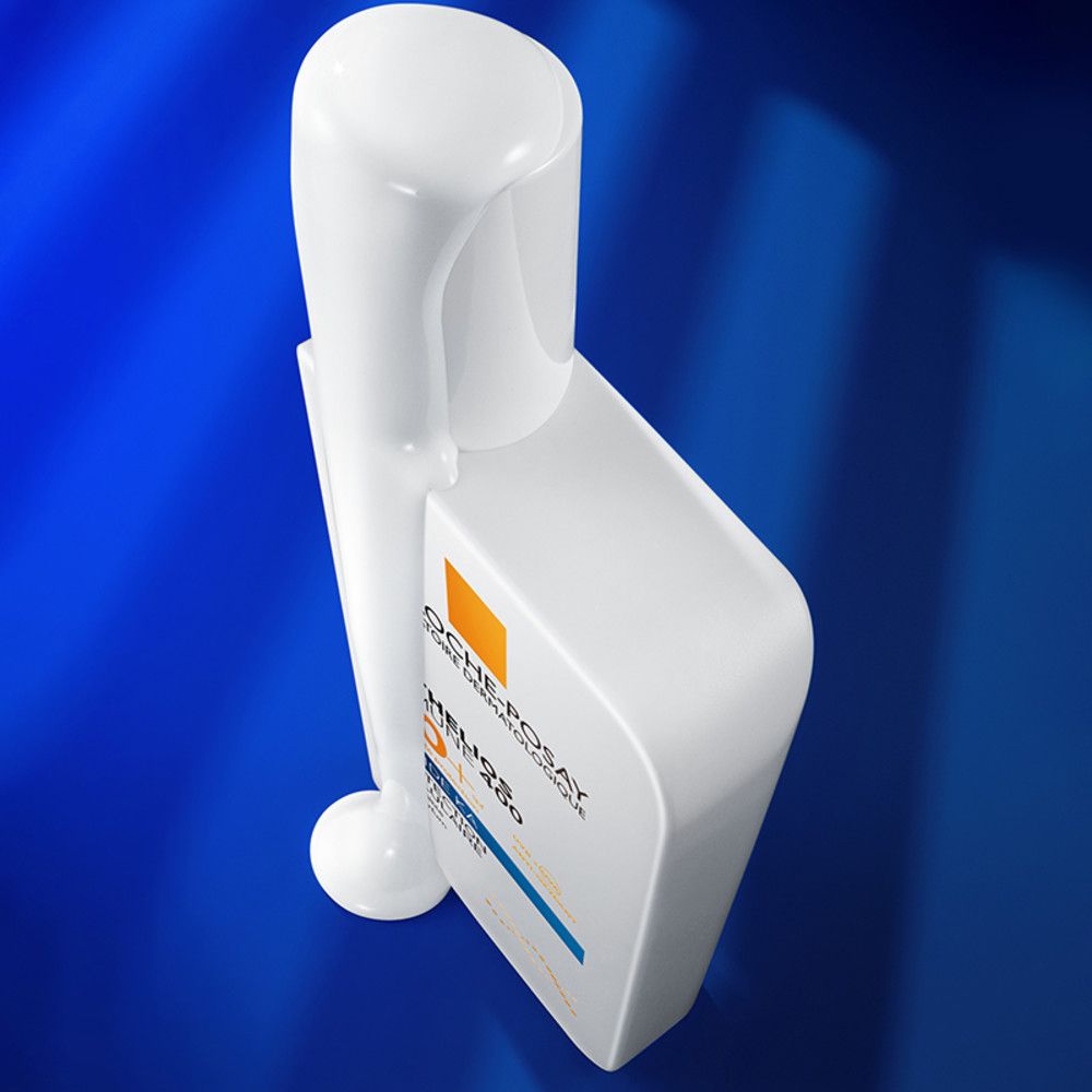 Flacon blanc avec bouchon blanc, vue de dessus. Inscription: La Roche-Posay, Anthelios UVMune 400 50+ Fluide KA.