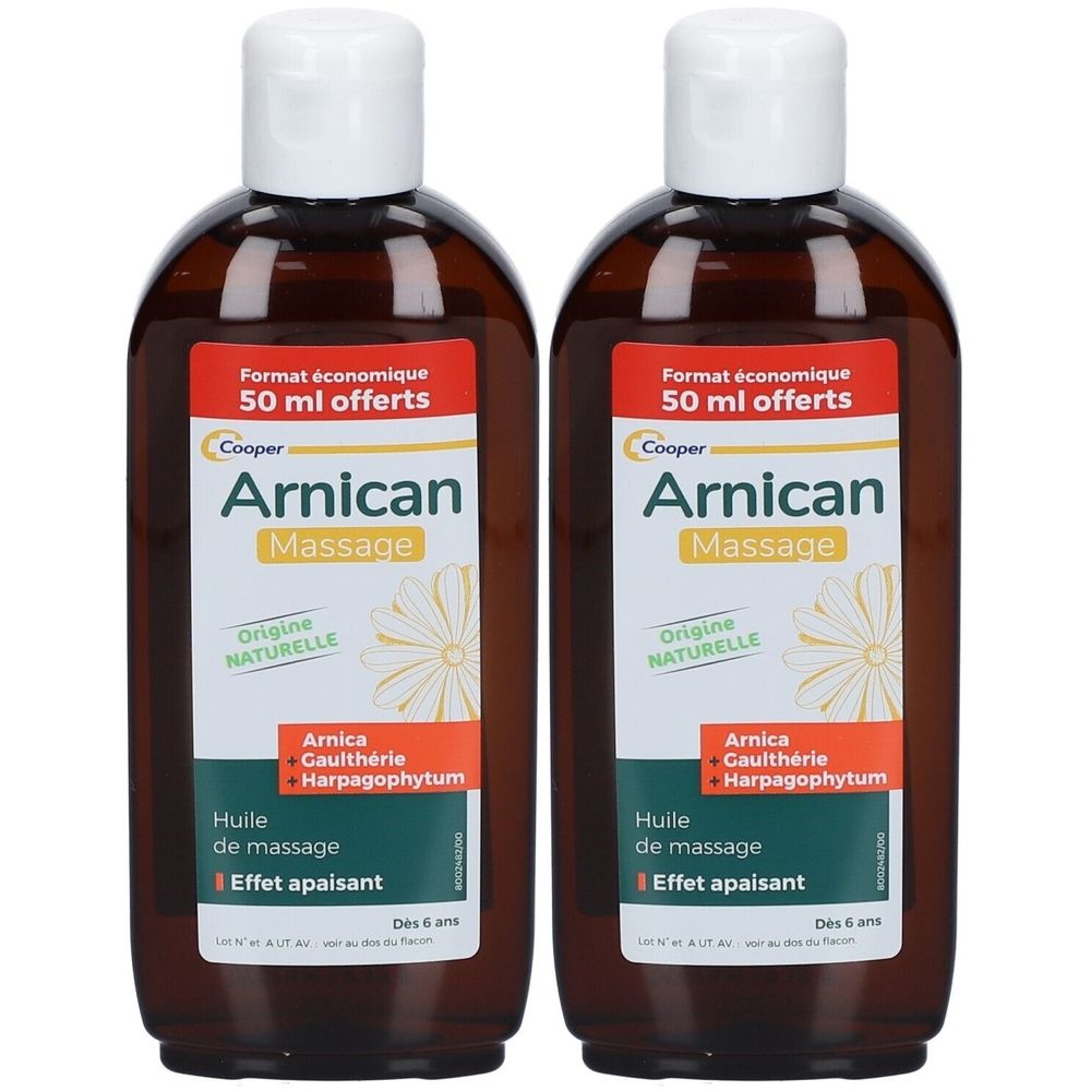 Deux flacons d'huile de massage Arnican. Flacons bruns avec bouchons blancs. Étiquettes rouges avec nom et ingrédients.