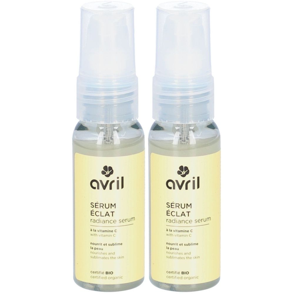 Deux flacons de Sérum Eclat AVRIL. Liquide clair dans des flacons en verre avec vaporisateur. Étiquette jaune avec texte et logo.