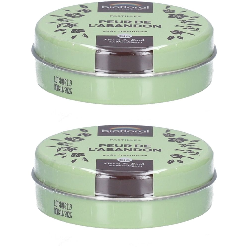 Deux boîtes rondes en métal vert avec l'inscription BIOFLORAL. Inscription : PEUR DE L'ABANDON. Visible : pastilles dans un emballage transparent.