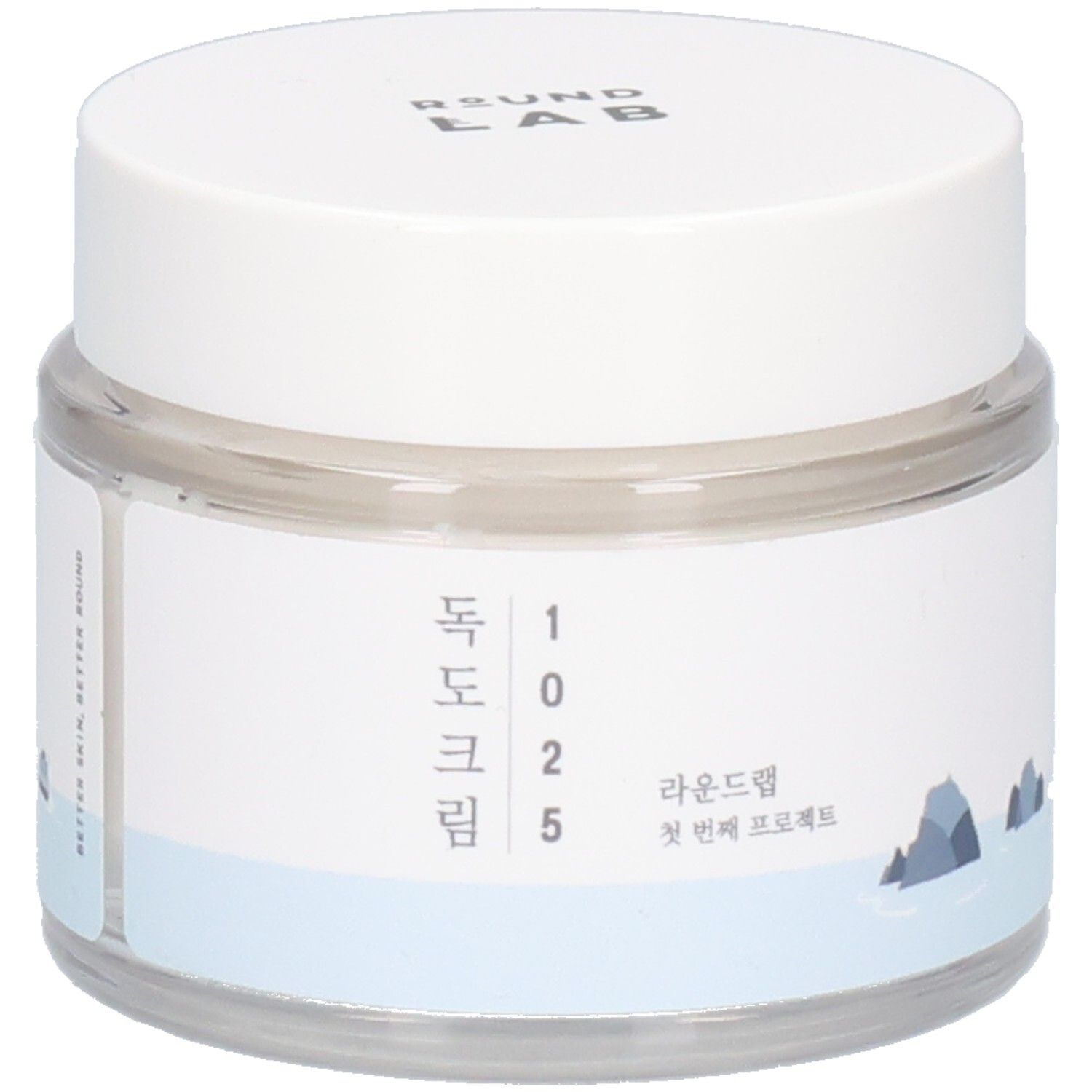 Pot rond transparent avec couvercle blanc. Étiquette avec texte coréen et logo. "ROUND LAB" en haut.
