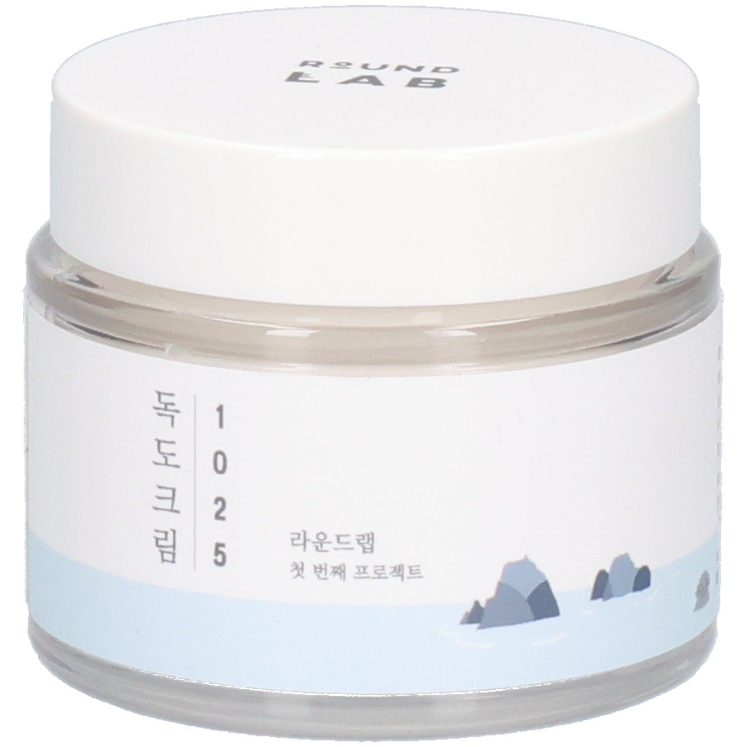 Pot rond transparent avec couvercle blanc. Étiquette avec texte coréen et logo. "ROUND LAB" en haut.