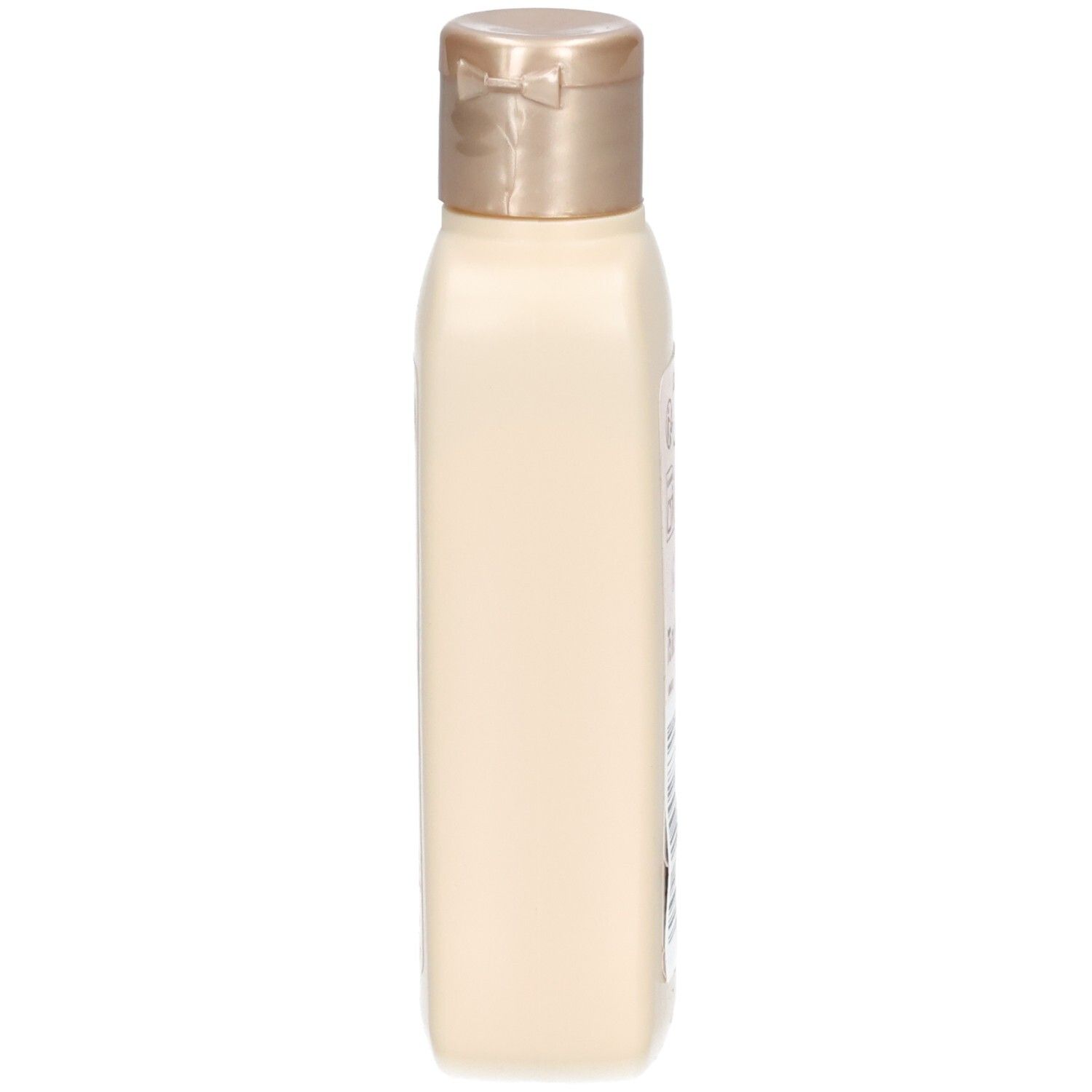Flacon de lotion beige, vue latérale. Bouchon doré. Forme rectangulaire.