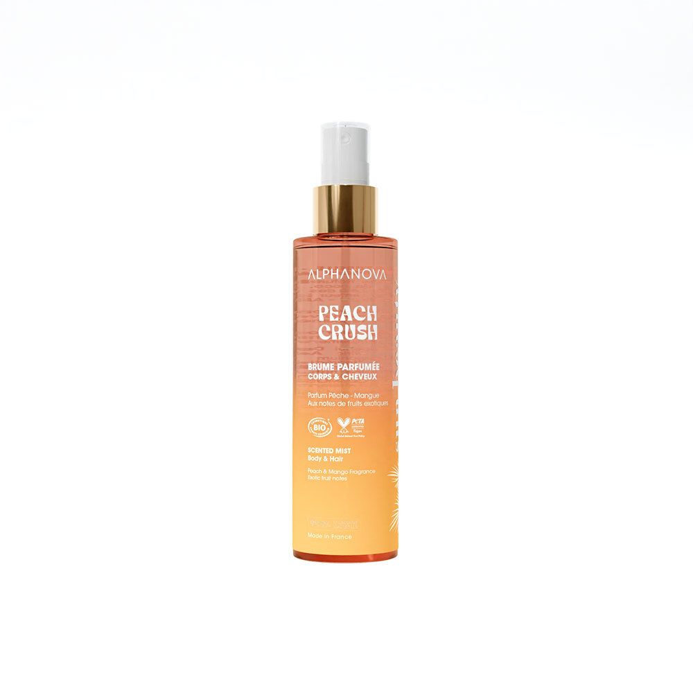 Flacon de brume parfumée corps et cheveux. Dégradé orange et jaune. Inscription PEACH CRUSH. Avec vaporisateur.