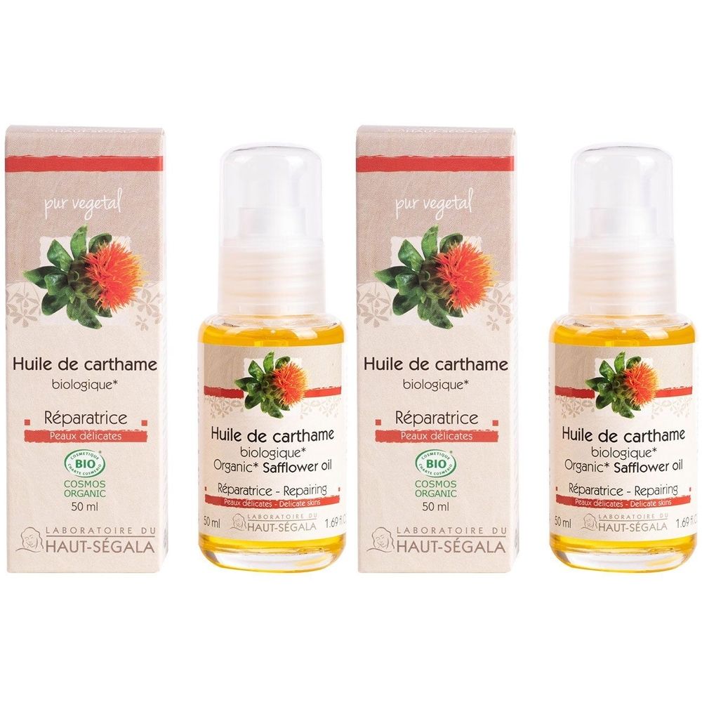 Quatre flacons d'huile jaune avec vaporisateur et boîtes. Inscription: Huile de carthame biologique, Réparatrice, certification BIO.