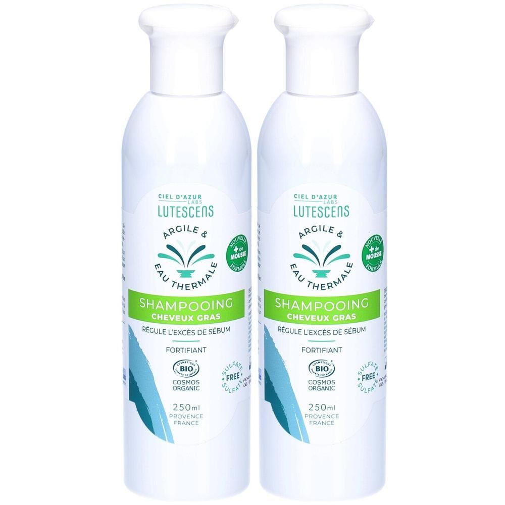 Deux flacons blancs de shampooing. Inscription: Lutescens, Argile & Eau Thermale. Vert: Shampooing Cheveux Gras. Certification bio.